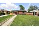 Well-manicured front yard showcasing a classic brick home with a neat walkway and adjacent properties at 2955 Poplar St, Denver, CO 80207