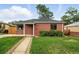 Charming brick home with a well-manicured front yard and a stone walkway leading to the entrance at 2955 Poplar St, Denver, CO 80207
