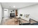 Cozy living room with white walls and matching sofa, complemented by stylish black armchairs and a round coffee table at 2955 Poplar St, Denver, CO 80207