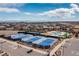 Aerial view showcasing community amenities including tennis courts, pool with waterslide, and clubhouse at 8234 S Vandriver Way, Aurora, CO 80016