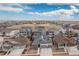 Expansive aerial view of a new construction residential neighborhood under a bright blue partially cloudy sky at 8234 S Vandriver Way, Aurora, CO 80016