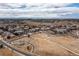 Aerial view showcases a neighborhood featuring a playground, green space, and mountain views in the background at 8234 S Vandriver Way, Aurora, CO 80016