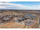 Community aerial view featuring a school, a lake, and a view of a neighborhood at 8234 S Vandriver Way, Aurora, CO 80016