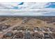 Neighborhood aerial view showcasing the community with a view of the plains and mountains in the distance at 8234 S Vandriver Way, Aurora, CO 80016