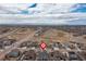 Wide aerial view of a residential community near open land with houses, streets, and a golf course at 8234 S Vandriver Way, Aurora, CO 80016