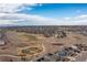 Aerial neighborhood view featuring green spaces, golf course, and panoramic mountain views in the distance at 8234 S Vandriver Way, Aurora, CO 80016