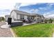 Well-maintained backyard with a hot tub, patio dining set, and lush green lawn at 8234 S Vandriver Way, Aurora, CO 80016