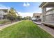 Spacious backyard with a lush lawn, patio dining set, and pergola, ideal for outdoor enjoyment at 8234 S Vandriver Way, Aurora, CO 80016