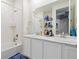 Bright bathroom features double sink vanity with marble countertop and tiled shower at 8234 S Vandriver Way, Aurora, CO 80016