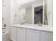 Bright bathroom with a double sink vanity, white cabinets, and a large mirror, offering a clean aesthetic at 8234 S Vandriver Way, Aurora, CO 80016