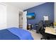 Bedroom with blue accent wall, tv, and desk at 8234 S Vandriver Way, Aurora, CO 80016
