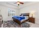 Cozy bedroom with a tray ceiling, a large window, and carpeted floors for a comfortable retreat at 8234 S Vandriver Way, Aurora, CO 80016