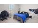 Comfortable bedroom with large window, neutral walls, and cozy decor at 8234 S Vandriver Way, Aurora, CO 80016