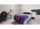 Comfortable bedroom with a desk for studying and a colorful quilt on the bed offers a cozy feel at 8234 S Vandriver Way, Aurora, CO 80016