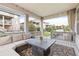 Inviting covered patio with comfortable seating and a fire pit, ideal for outdoor relaxation and entertainment at 8234 S Vandriver Way, Aurora, CO 80016