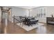 Dining table with a bench and chairs is staged on a patterned rug at 8234 S Vandriver Way, Aurora, CO 80016