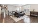 Bright dining area features a unique table and bench seating, with dark wood floors and stylish decor at 8234 S Vandriver Way, Aurora, CO 80016