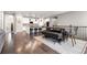 Open-concept dining area boasts stylish furniture with a unique table and a view of the modern kitchen at 8234 S Vandriver Way, Aurora, CO 80016