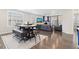 A dining table with a bench and chairs leads to a cozy living area with a fireplace at 8234 S Vandriver Way, Aurora, CO 80016