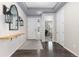 Inviting foyer featuring hardwood floors, a stylish mirror, and views of the office at 8234 S Vandriver Way, Aurora, CO 80016