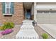 Inviting front entrance with stone accents, concrete steps, and a storm door at 8234 S Vandriver Way, Aurora, CO 80016