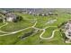 Scenic aerial view of a lush golf course winding through a residential neighborhood with streams and green space at 8234 S Vandriver Way, Aurora, CO 80016