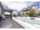 Backyard patio featuring a hot tub, dining table and chairs, and a covered porch at 8234 S Vandriver Way, Aurora, CO 80016