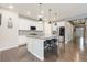 Stylish kitchen with white cabinets, stainless steel appliances, granite countertops, and a large island at 8234 S Vandriver Way, Aurora, CO 80016