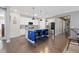 Bright kitchen with a blue island, stainless steel appliances, and stylish pendant lighting at 8234 S Vandriver Way, Aurora, CO 80016
