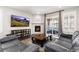 Inviting living room showcases a cozy fireplace, a large TV, and access to the outdoor patio at 8234 S Vandriver Way, Aurora, CO 80016