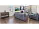 Living room includes a fireplace, sliding door, and furniture with wood flooring at 8234 S Vandriver Way, Aurora, CO 80016