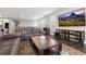 Comfortable living room with a large TV, dark wood floors, and a rustic wood coffee table at 8234 S Vandriver Way, Aurora, CO 80016
