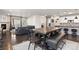 Open living space with dining area, modern kitchen, and cozy living room with fireplace and backyard access at 8234 S Vandriver Way, Aurora, CO 80016