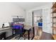 Home office featuring dual monitor setup, hardwood floors, and French doors to kitchen at 8234 S Vandriver Way, Aurora, CO 80016