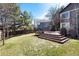 Spacious backyard with a wood deck, lawn, and some trees on a beautiful sunny day at 10028 Chelmsford Ter, Parker, CO 80134