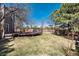 Backyard with wooden fence, trees and deck area at 10028 Chelmsford Ter, Parker, CO 80134