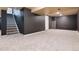 Spacious finished basement featuring neutral carpet, gray accent walls and staircase access at 10028 Chelmsford Ter, Parker, CO 80134