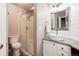 Well-lit bathroom with a glass shower, single sink vanity and shiplap wall at 10028 Chelmsford Ter, Parker, CO 80134