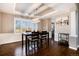 Dining room with hardwood floors, wainscoting, modern light fixture, and wine rack at 10028 Chelmsford Ter, Parker, CO 80134