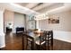 Dining room with hardwood floors and a modern chandelier, adjacent to the living room at 10028 Chelmsford Ter, Parker, CO 80134