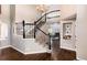 Elegant entryway featuring a grand staircase with black iron railings and hardwood floors at 10028 Chelmsford Ter, Parker, CO 80134