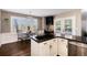 Eat-in kitchen with granite counters, stainless sink, wood floors, and large window at 10028 Chelmsford Ter, Parker, CO 80134