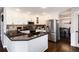 Modern kitchen with white cabinets, stainless steel appliances, and dark granite countertops at 10028 Chelmsford Ter, Parker, CO 80134