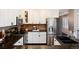 Kitchen with stainless steel appliances, tile backsplash, dark granite counters and white cabinets at 10028 Chelmsford Ter, Parker, CO 80134
