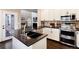 Bright kitchen with granite countertops, stainless steel appliances, and white cabinets at 10028 Chelmsford Ter, Parker, CO 80134