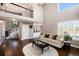 Bright living room with fireplace, high ceilings, and open staircase at 10028 Chelmsford Ter, Parker, CO 80134