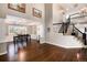 Open concept living and dining room with hardwood floors and modern black table at 10028 Chelmsford Ter, Parker, CO 80134