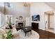 Cozy living room with a stone fireplace and high ceilings at 10028 Chelmsford Ter, Parker, CO 80134