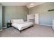 Bright main bedroom features a high ceiling, soft green walls, and easy access to the ensuite bathroom at 10028 Chelmsford Ter, Parker, CO 80134