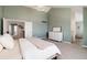 Spacious main bedroom with soft green walls features a high ceiling and easy access to the ensuite bathroom at 10028 Chelmsford Ter, Parker, CO 80134